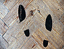 Souls/soles charcoal pair of footprint on church floor II