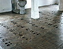 Souls/soles charcoal footprint on church floor II